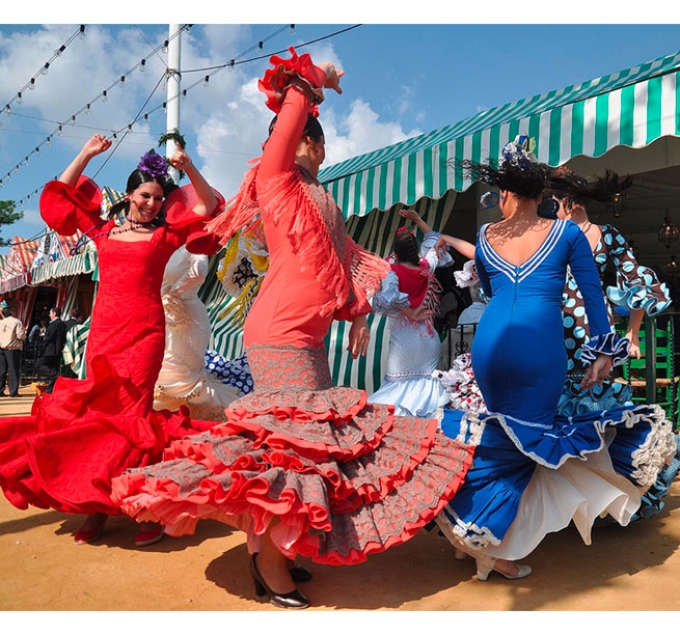 Women in traditional flamenco dresses.